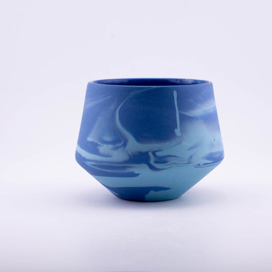 Blue marbled ceramic cup on a white background